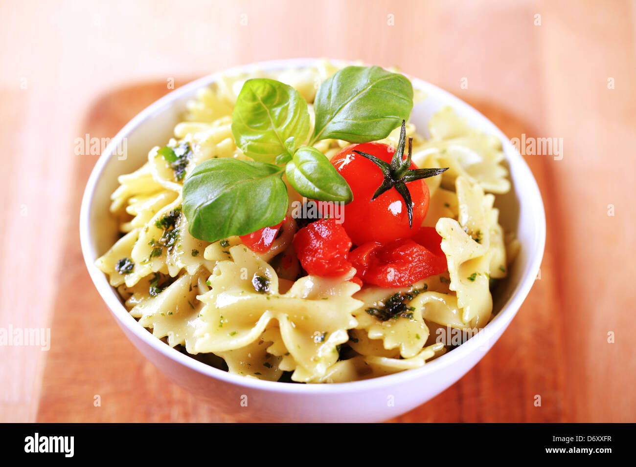 Bow tie pasta with pesto and tomato Stock Photo Alamy