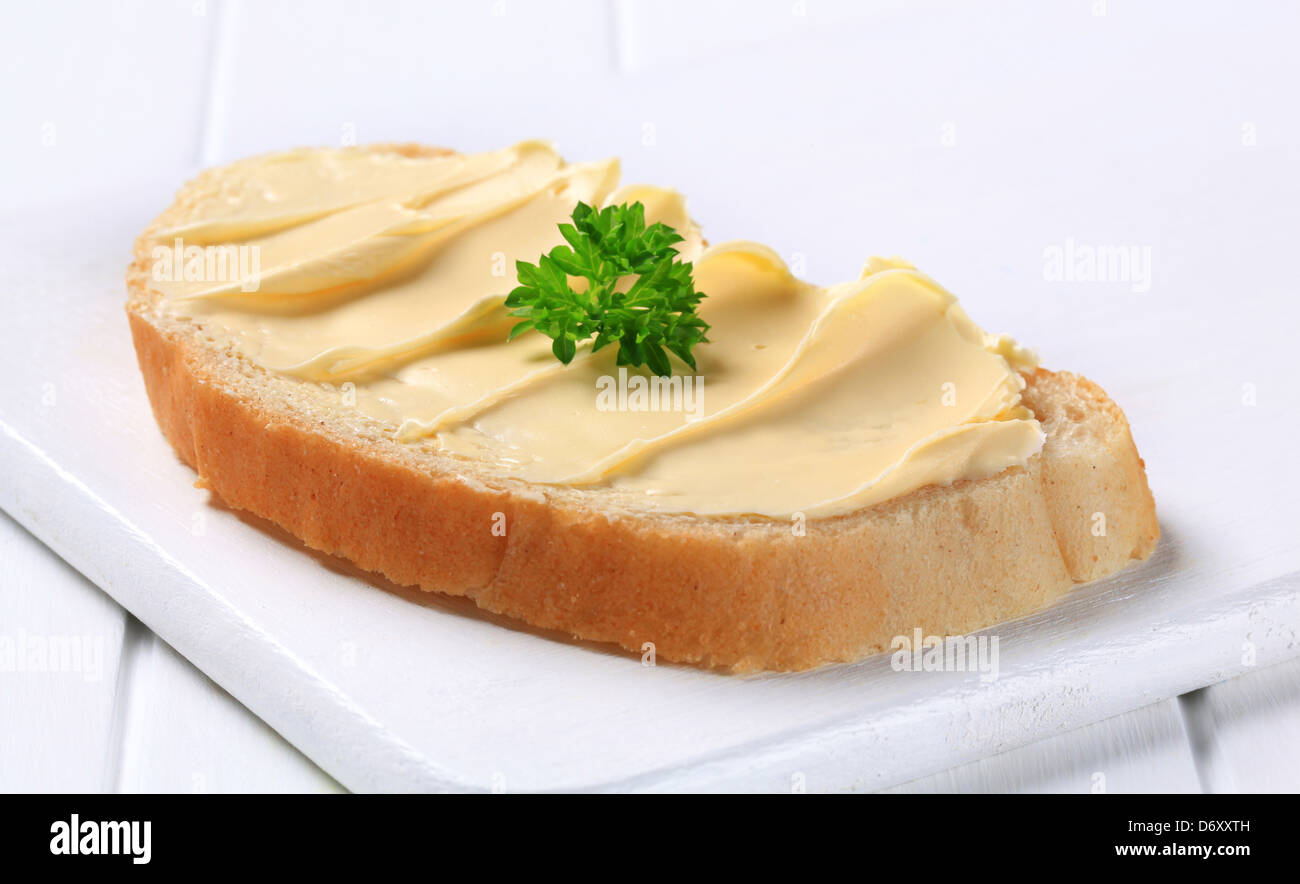 Slice of white bread with butter Stock Photo Alamy