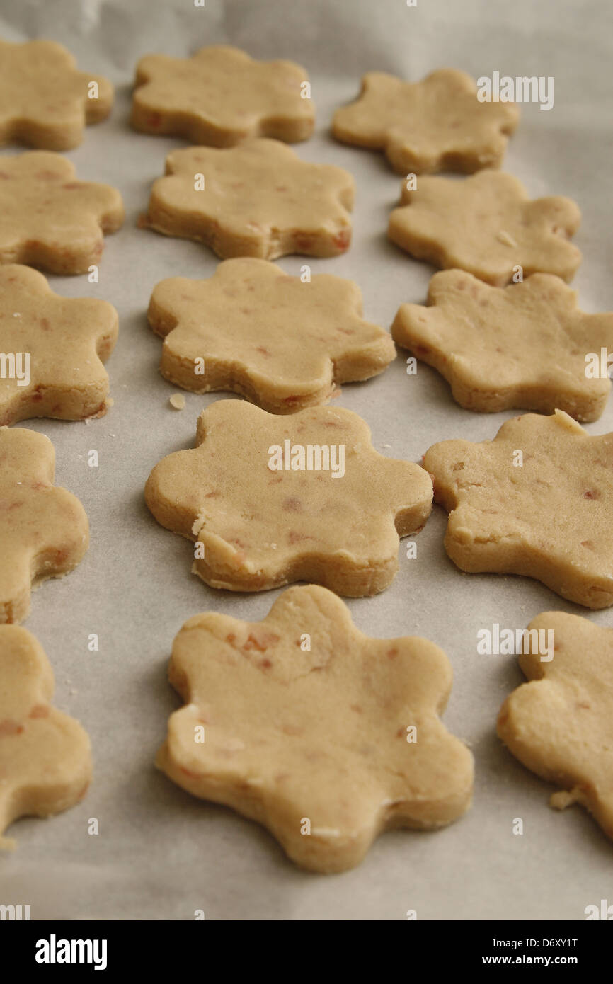 homemade cherry shortbread biscuits on baking parchment Stock Photo