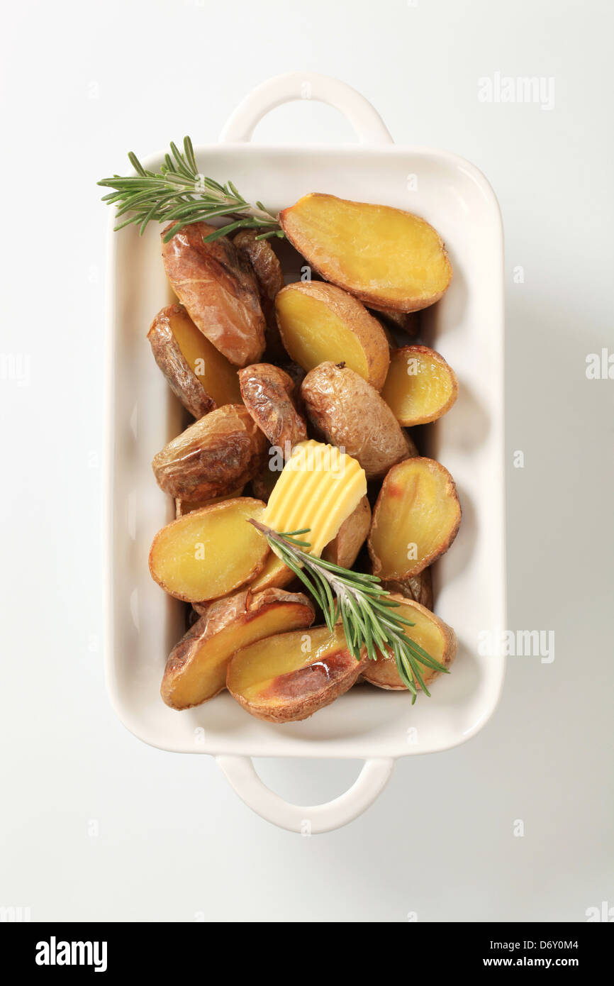 Halves of baked potatoes in a casserole dish Stock Photo