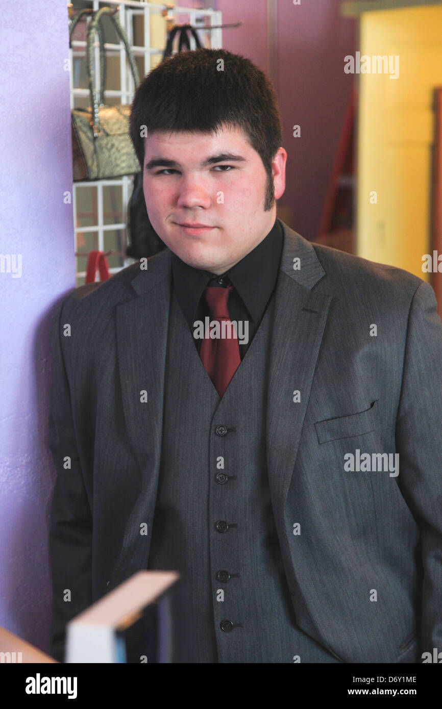Ambitious teenage male accountant working for a nonprofit women's used clothing shop. St Paul Minnesota MN USA Stock Photo