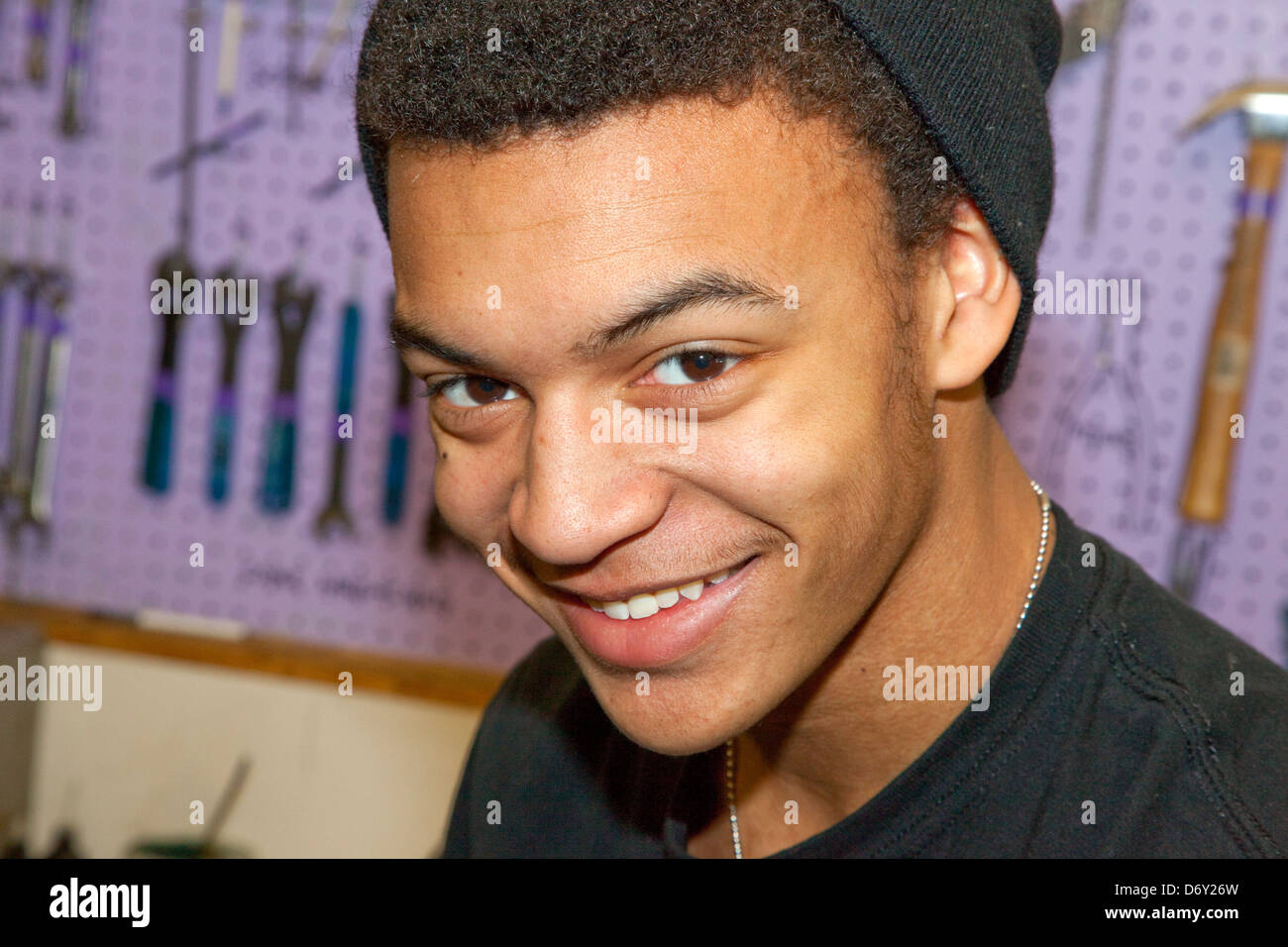 Happy black teenager working at the nonprofit Youth Express Bike Repair