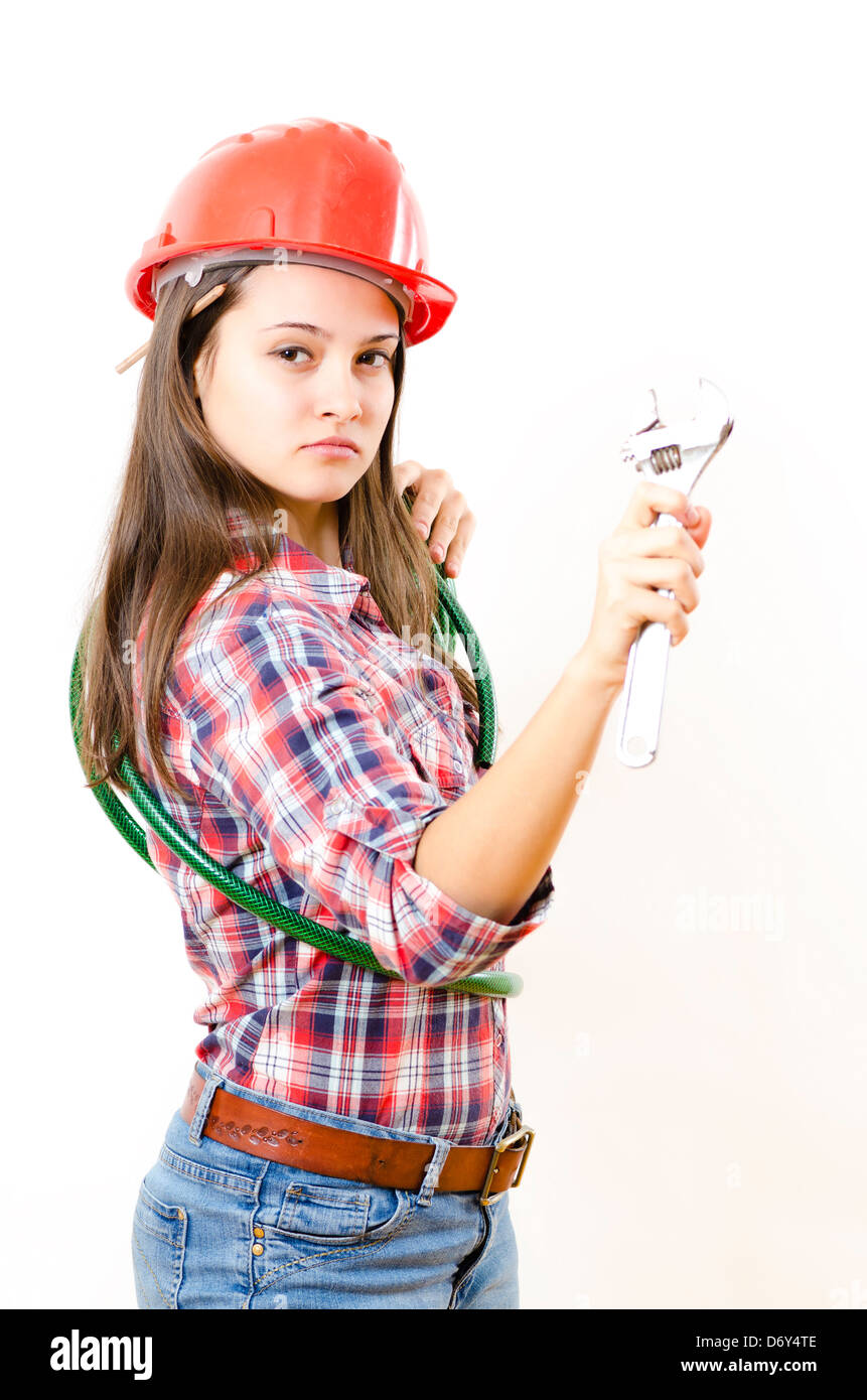 Woman wearing protective equipment holding adjustable wrench Stock