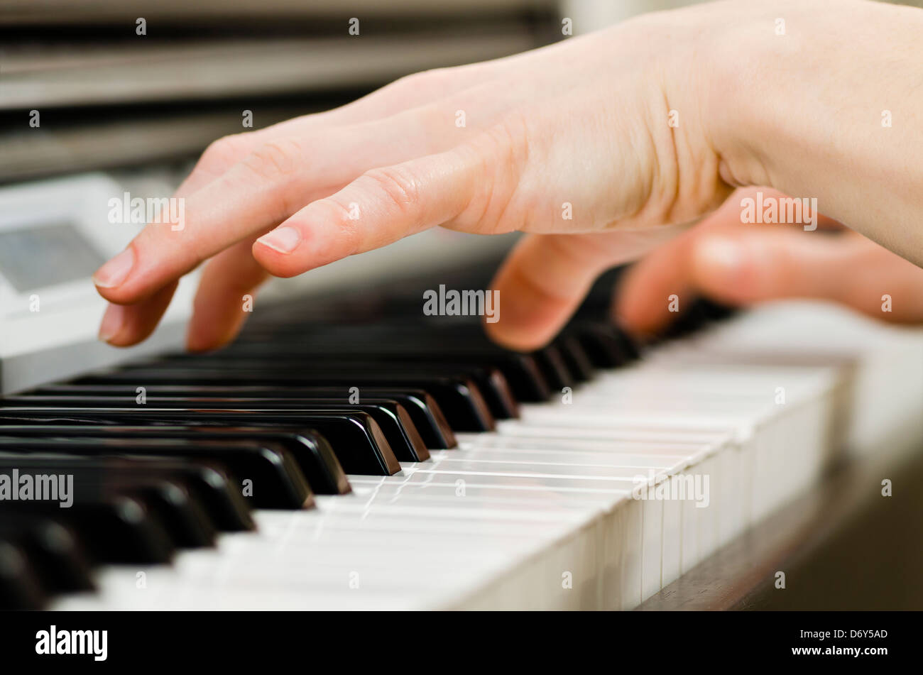 Close up of the hands of a young woman playing piano Stock Photo