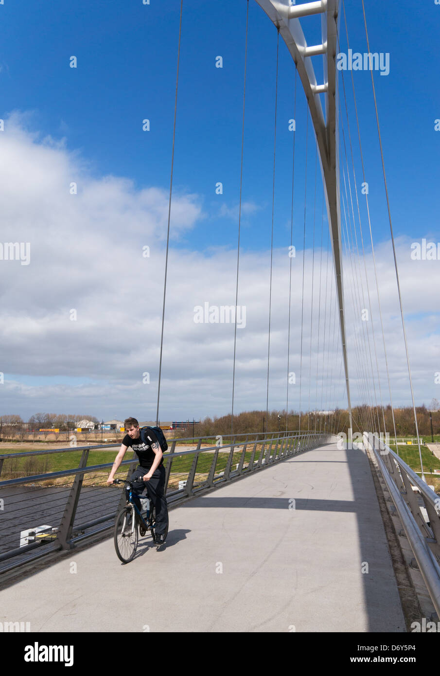 Cyclist crossing Infinity Bridge Stockton-on-Tees north east England UK Stock Photo