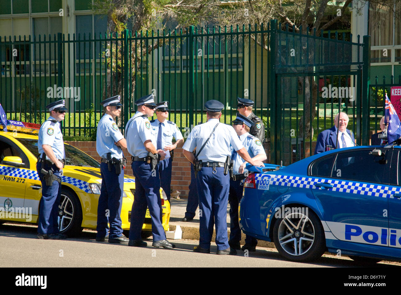 Australian police officers in uniform stood beside two Holden police cars, Sydney,NSW, Australia Stock Photo