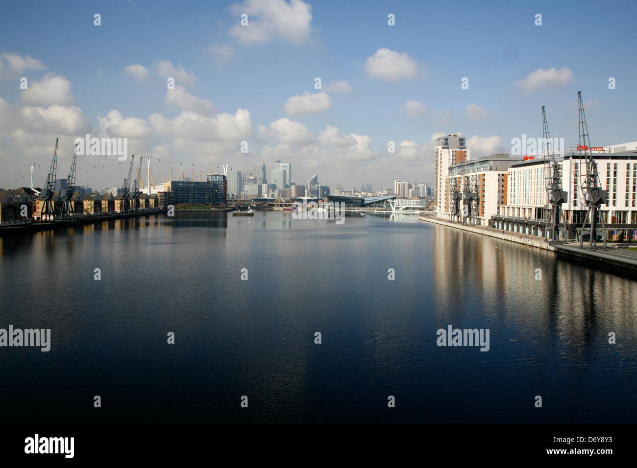 View along Royal Victoria Dock towards Canary Wharf in the far distance, Docklands, London, UK Stock Photo