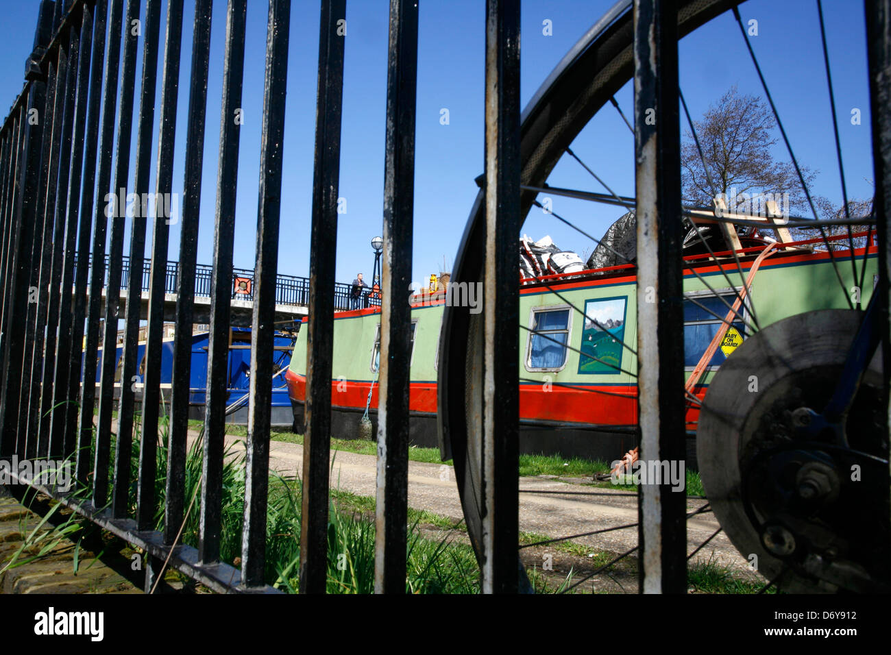 View through the railings to a canal boat moored on the Regent's Canal beside Delamere Terrace, Maida Vale, London, UK Stock Photo