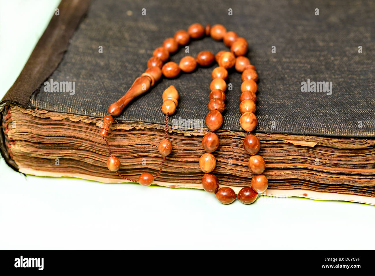 An ancient hand scripted Quran with prayer beads Stock Photo