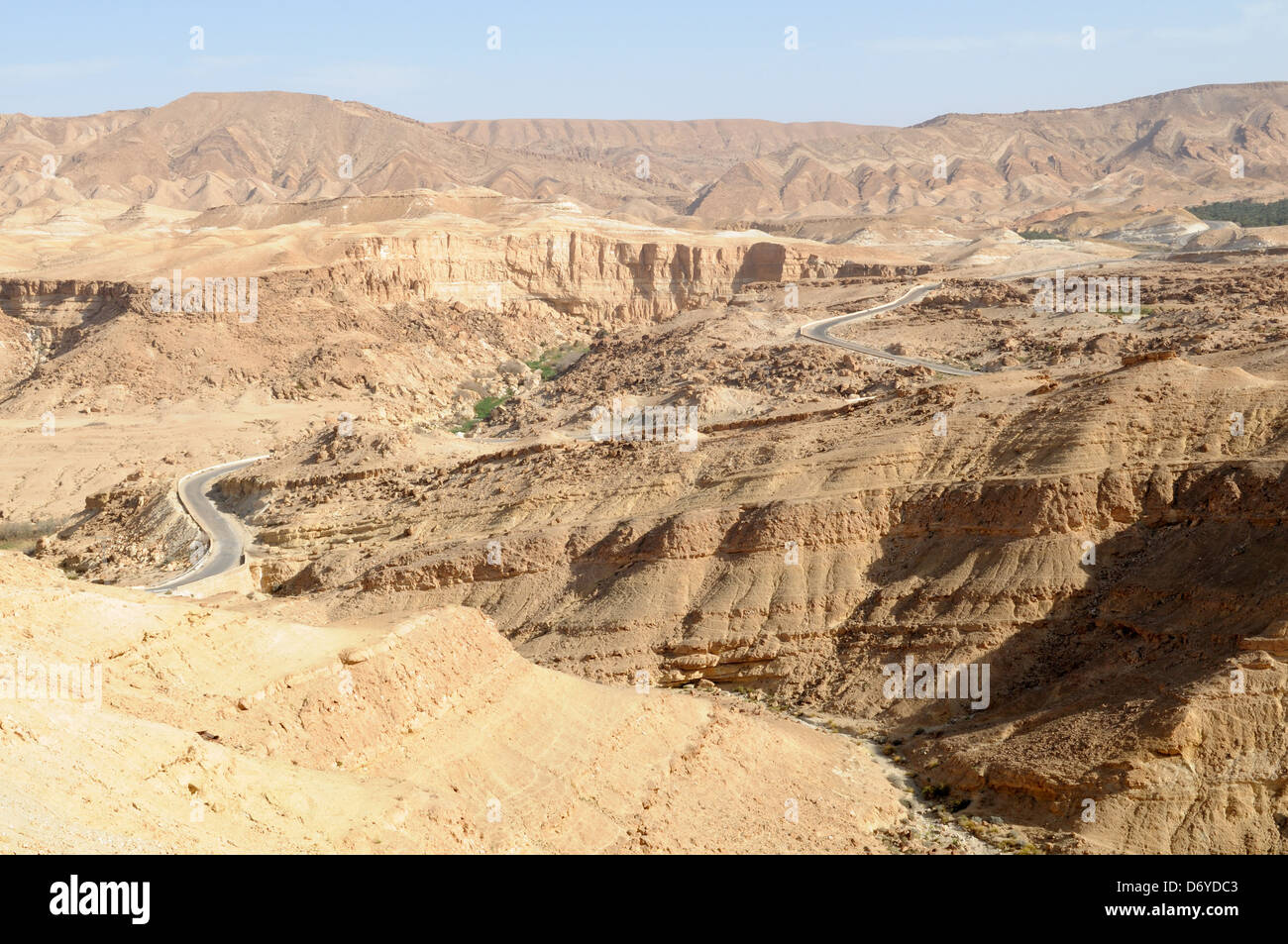 Road winding its way through the Atlas Mountains towards Tamerza Oasis tunisia Stock Photo