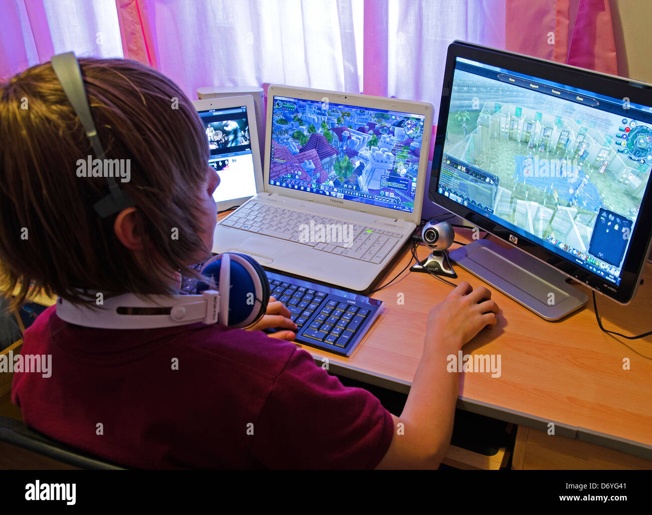 A teenage boy playing computer games in his bedroom Stock Photo