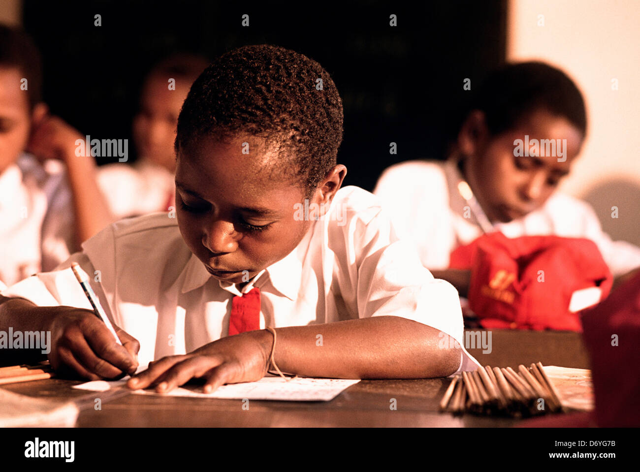 Male students studying in a classroom, Irian Jaya, New Guinea, Indonesia Stock Photo