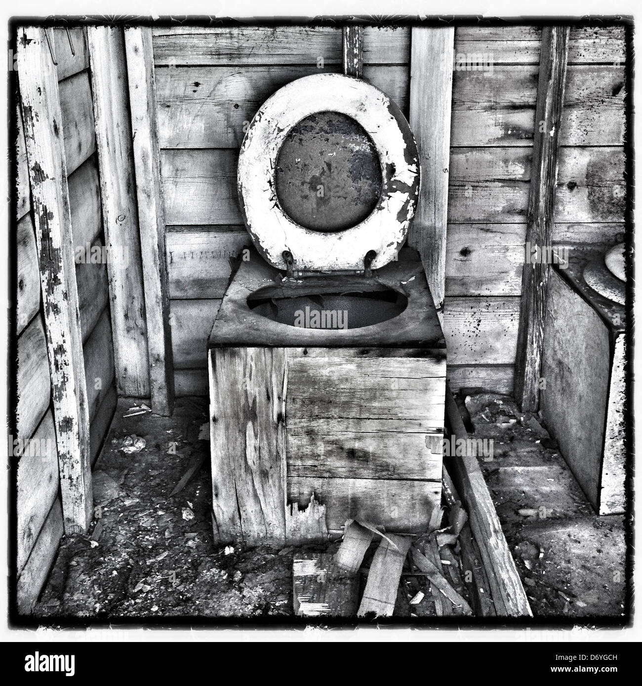 Dilapidated wooden toilet in outhouse - Smartphone Captured Stock Image