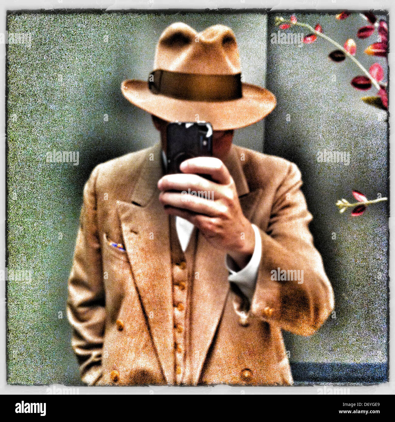 Caucasian man in old-fashioned clothing using cell phone Stock Photo