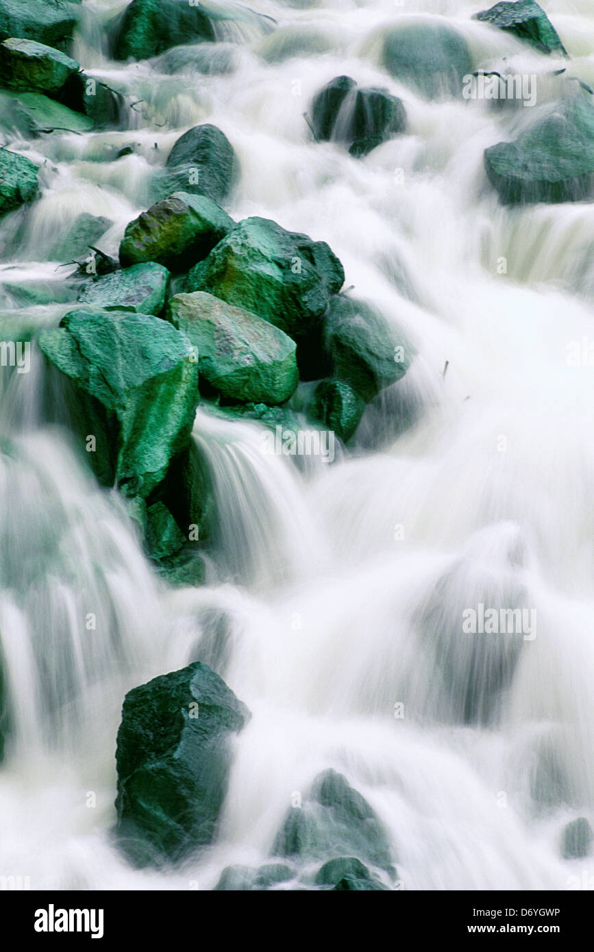 Water rushing over green rocks, Irian Jaya, New Guinea, Indonesia Stock ...