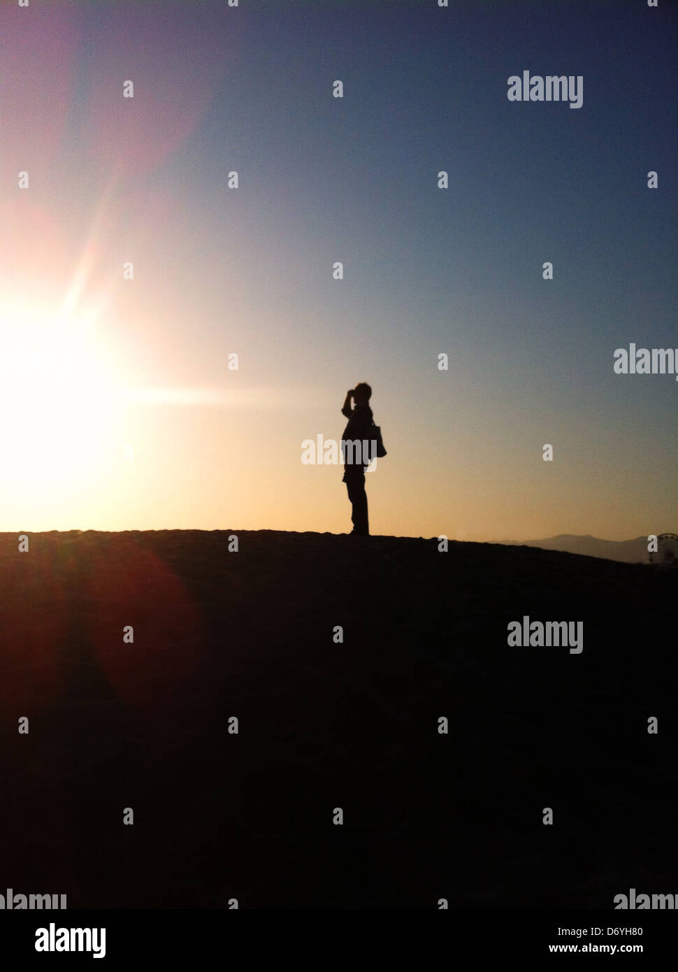 Silhouette of man on hill at sunset - Smartphone Captured Stock Image