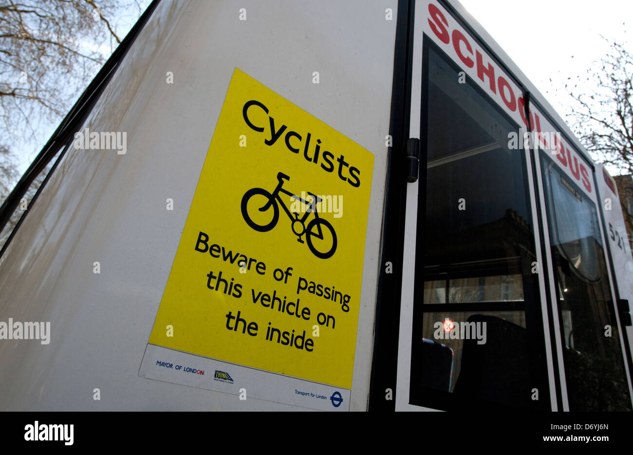 Safety warning notice for cyclists on back of school bus, London Stock Photo