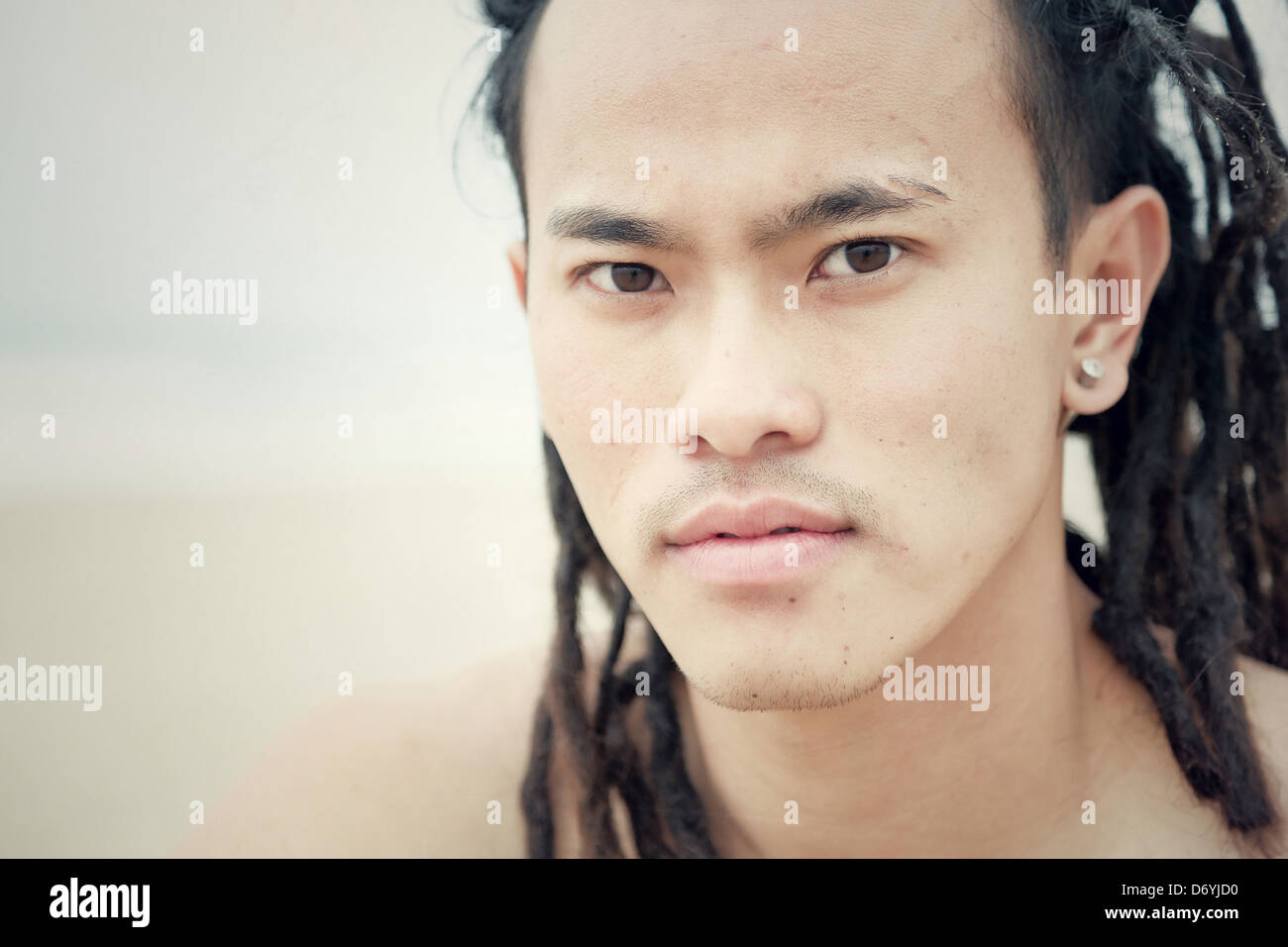 Serious Chinese man with dreadlocks - Smartphone Captured Stock Image