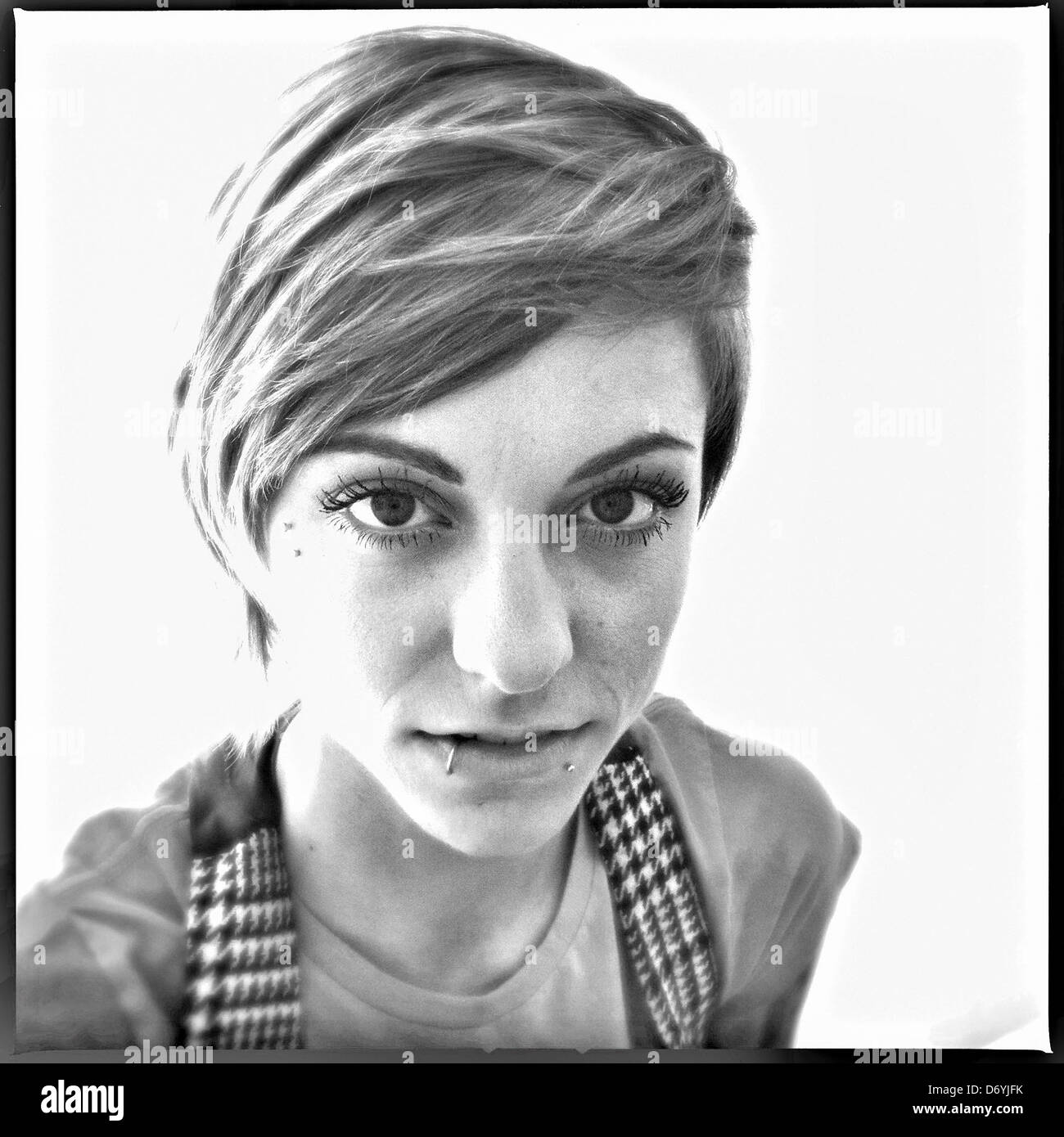 Serious Caucasian man with lip piercing - Smartphone Captured Stock Image