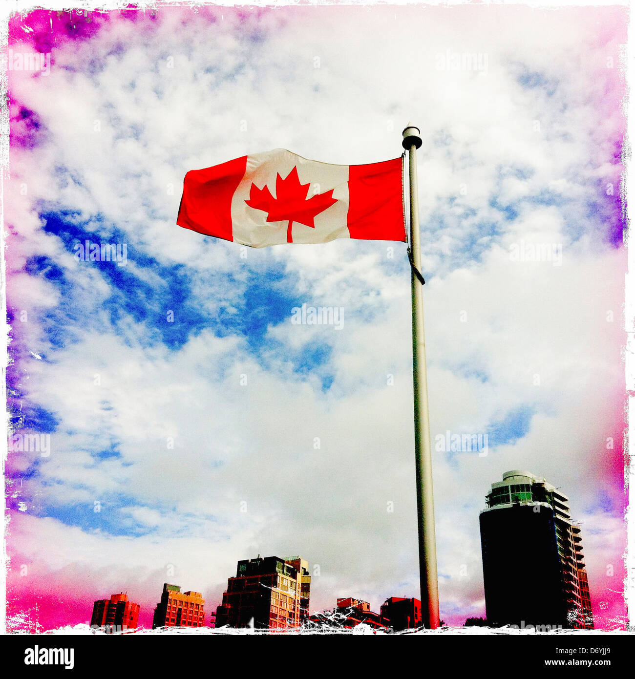 Canadian flag flying on top of flag pole - Smartphone Captured Stock Image