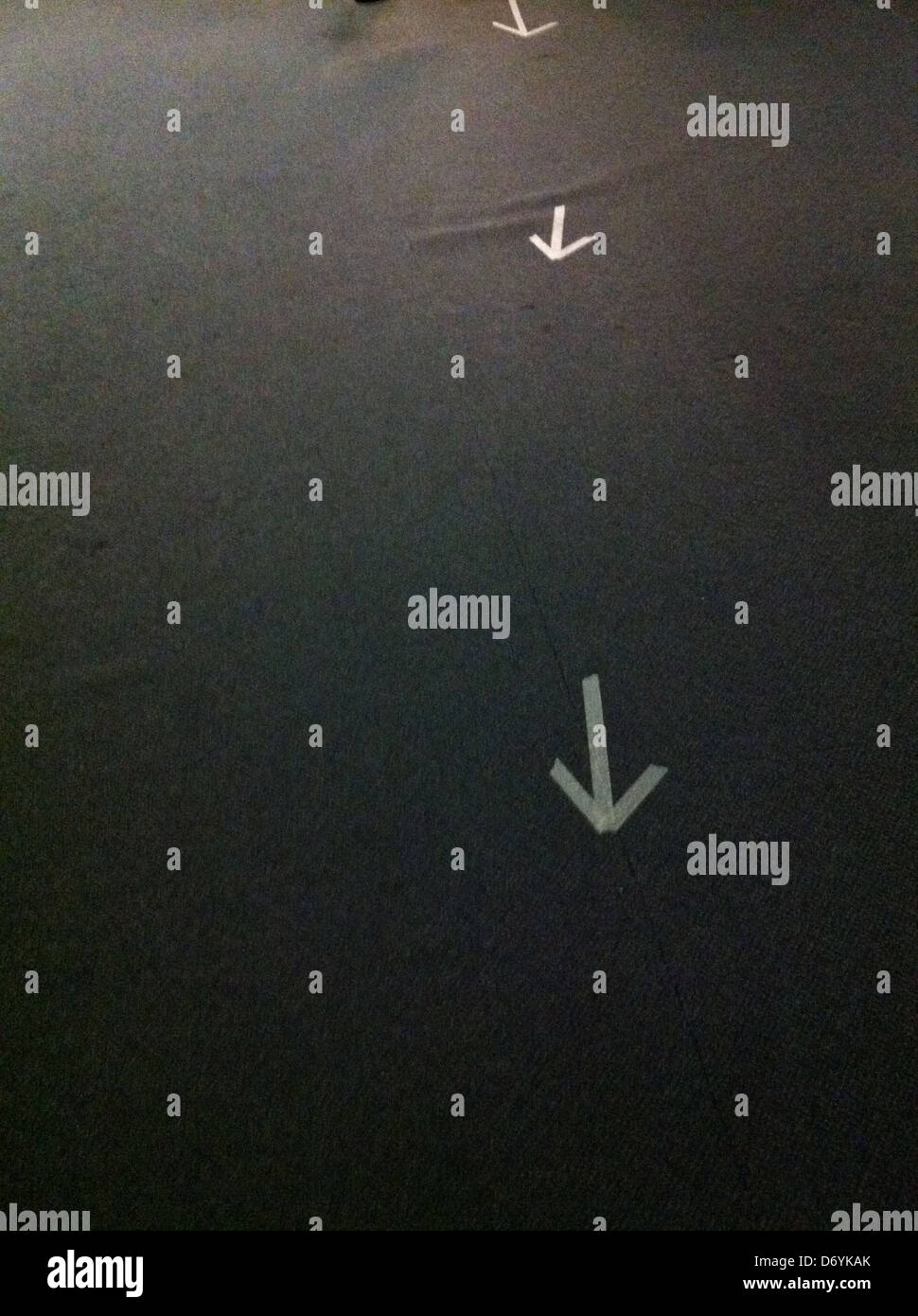 Masking tape arrows on carpet Stock Photo Alamy