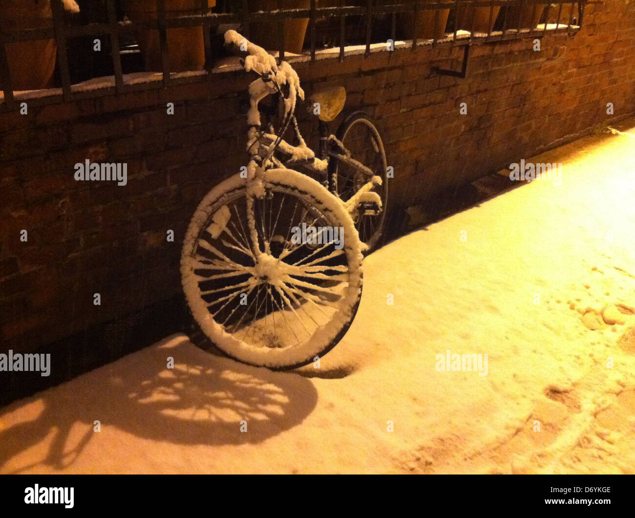 Snow covered bicycle on city street - Smartphone Captured Stock Image