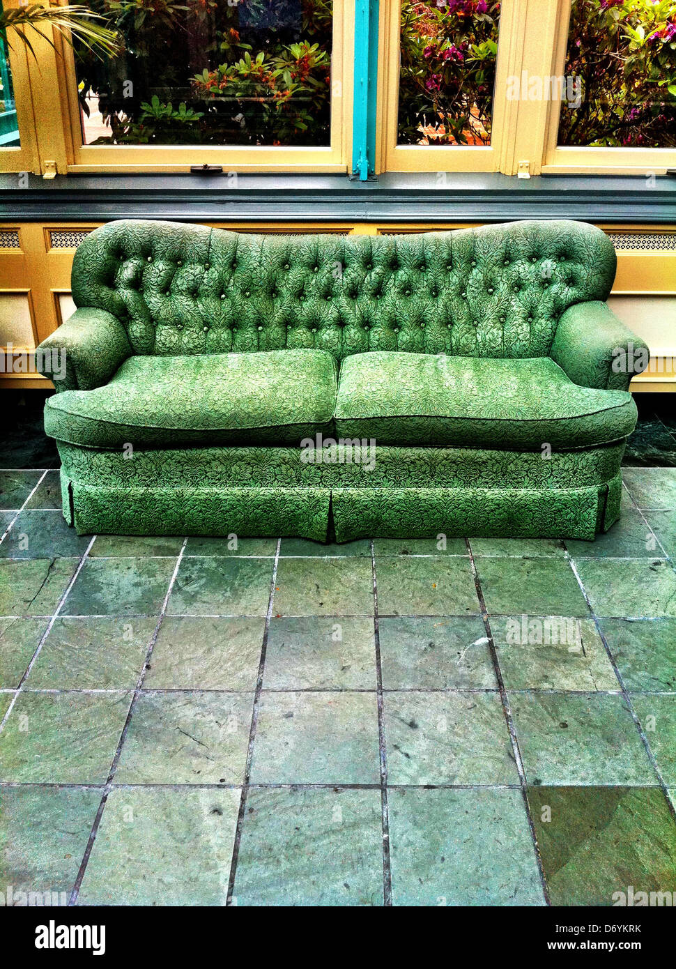 Sofa on stone tile floor Stock Photo