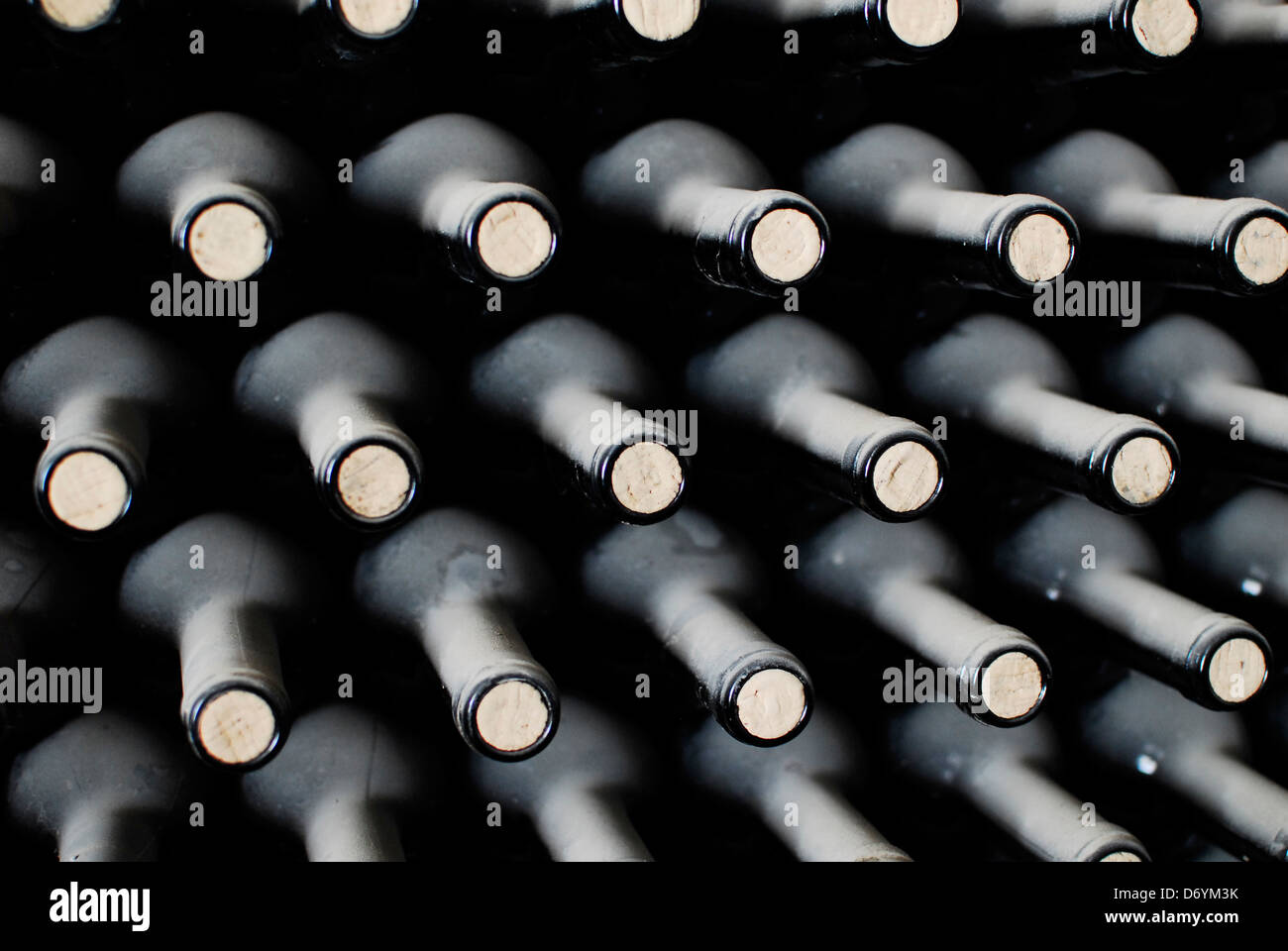 stacked up of old wine bottles in the cellar Stock Photo