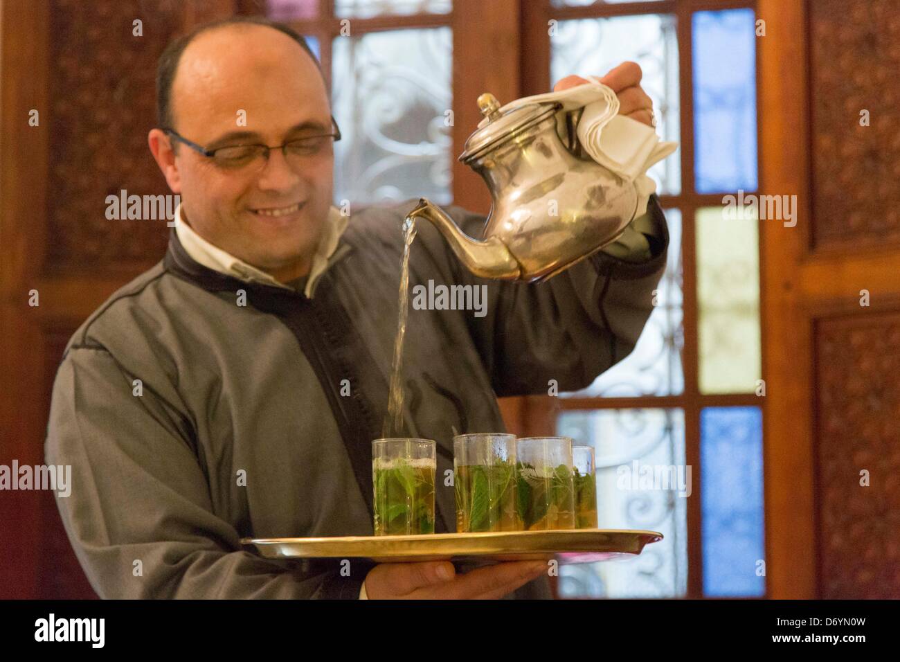 traditional mint tea ceremony in a restaurant in Fez, Marocco Stock Photo