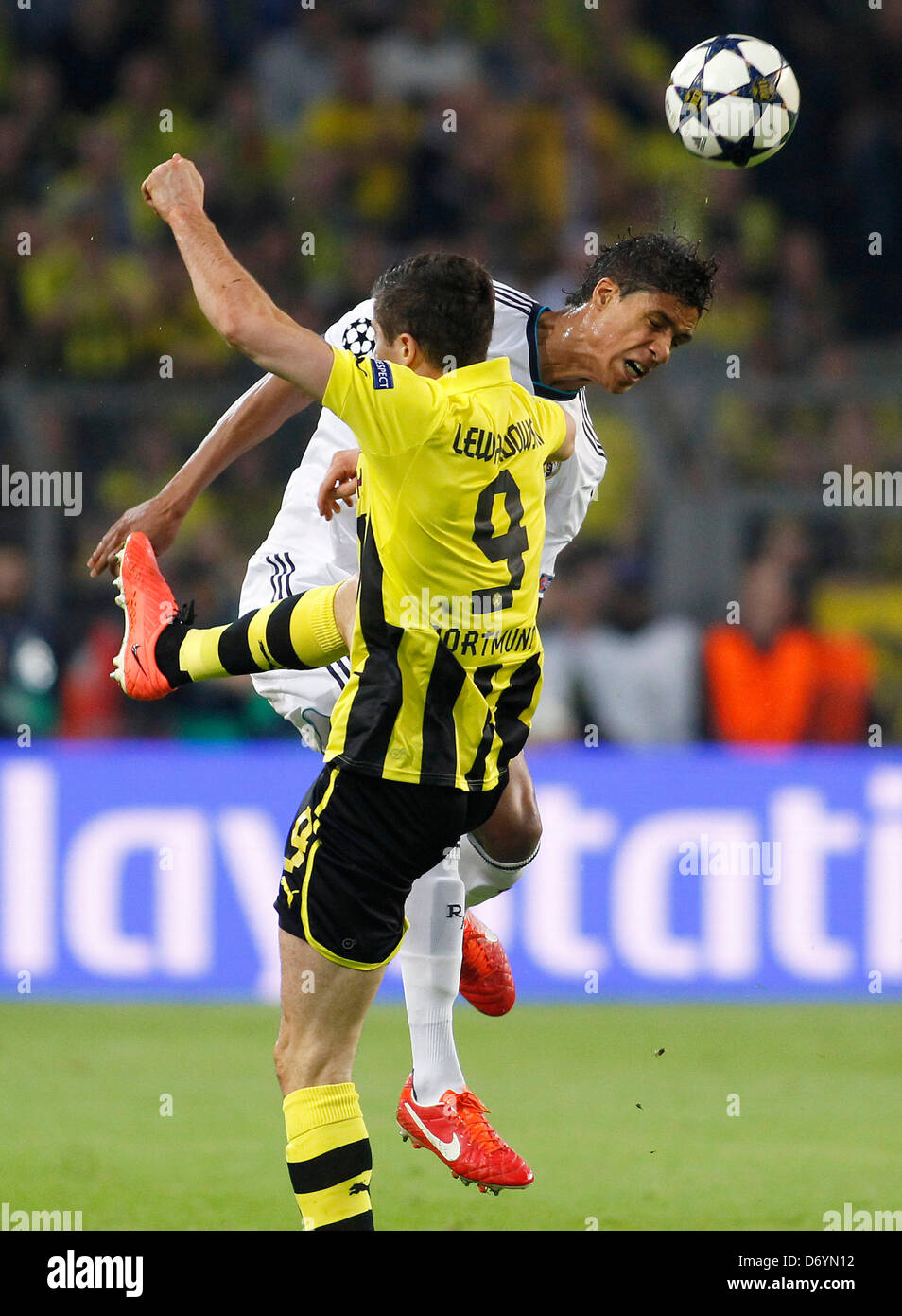 Madrid's Raphael Varane jumps for a header against Dortmund's Robert ...