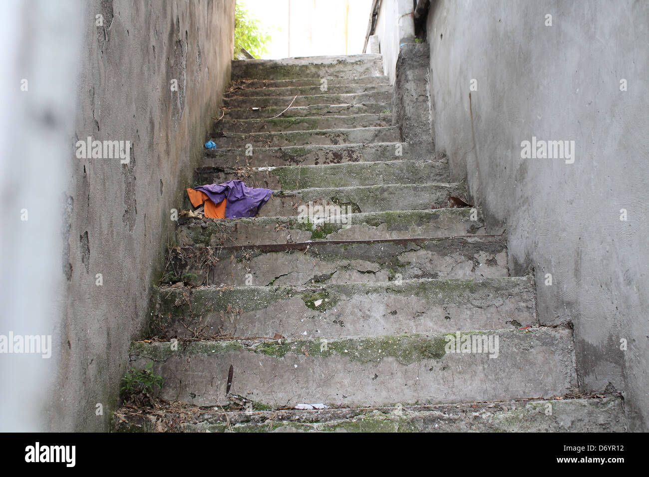 An Old stone staircase with abandoned clothing Stock Photo