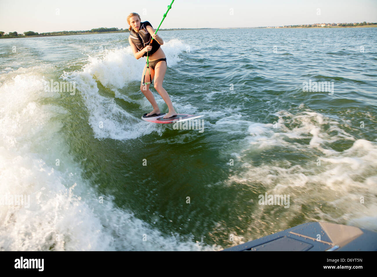 Teenage girl wakeboarding on lake Stock Photo Alamy