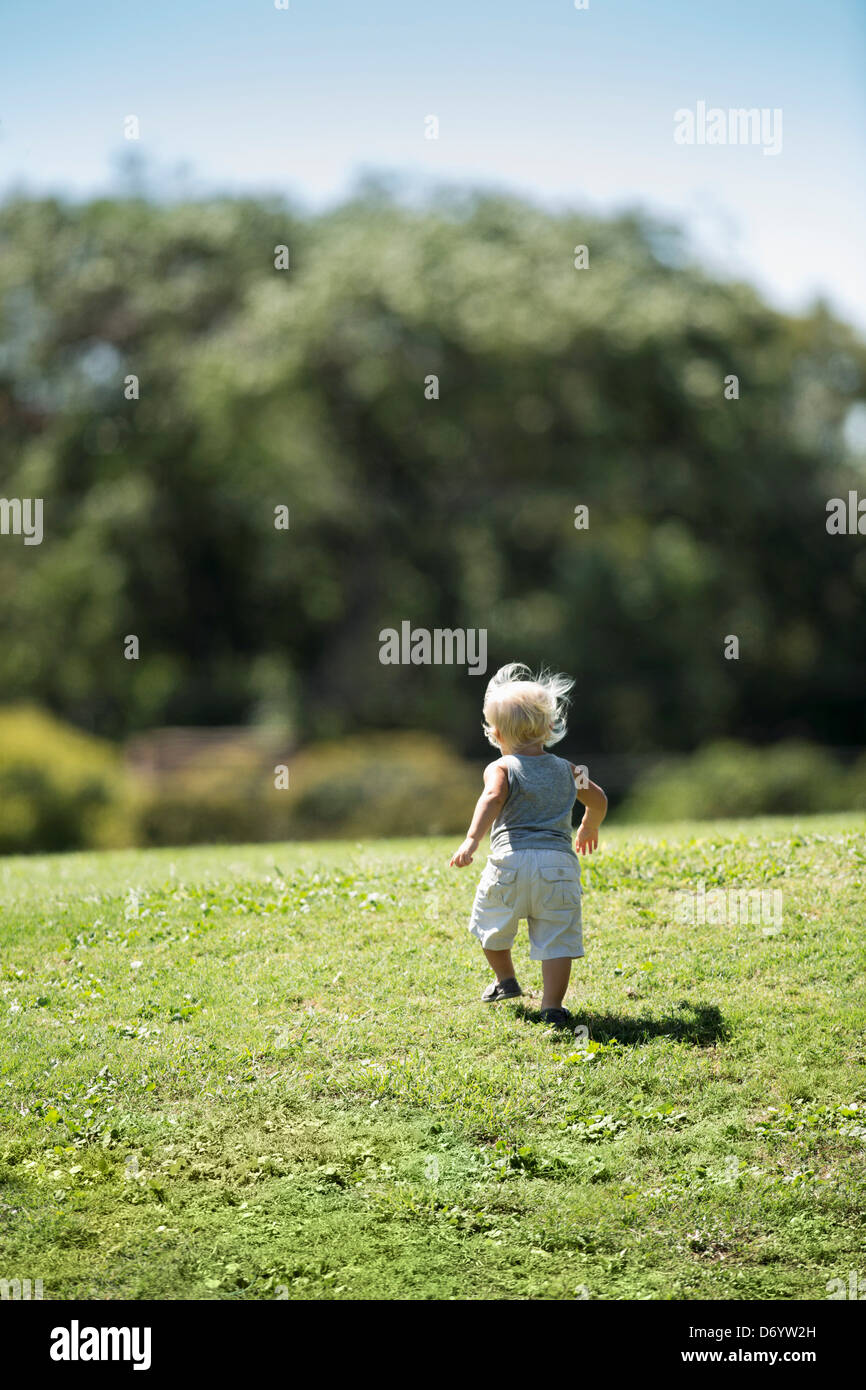 Child Running Fast Rear View Rear view of child running up hill Stock Photo - Alamy