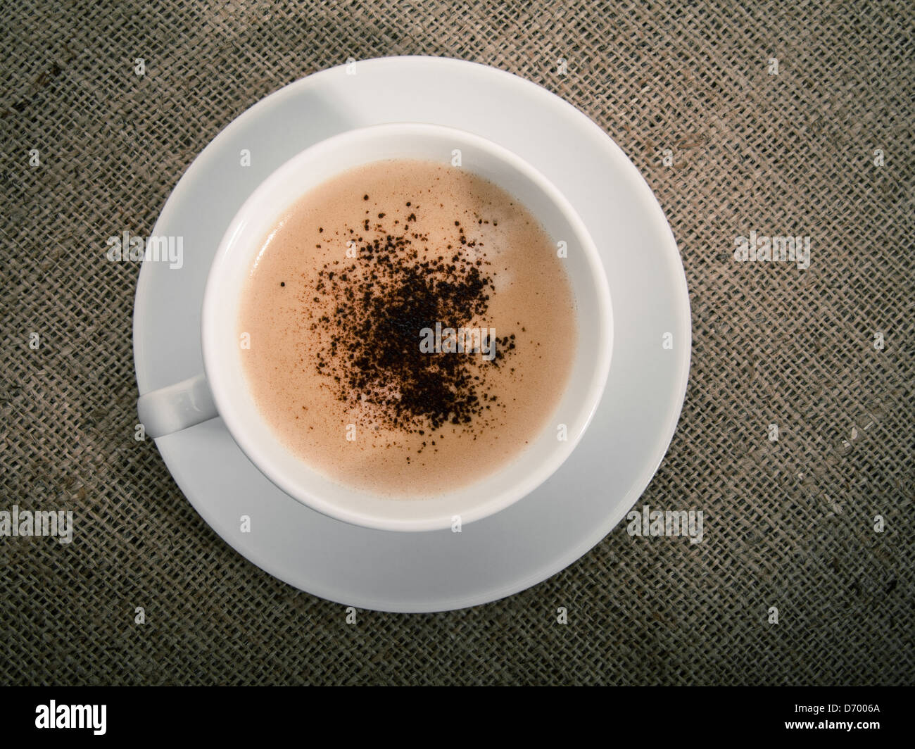 Black coffee over old burlap background Stock Photo