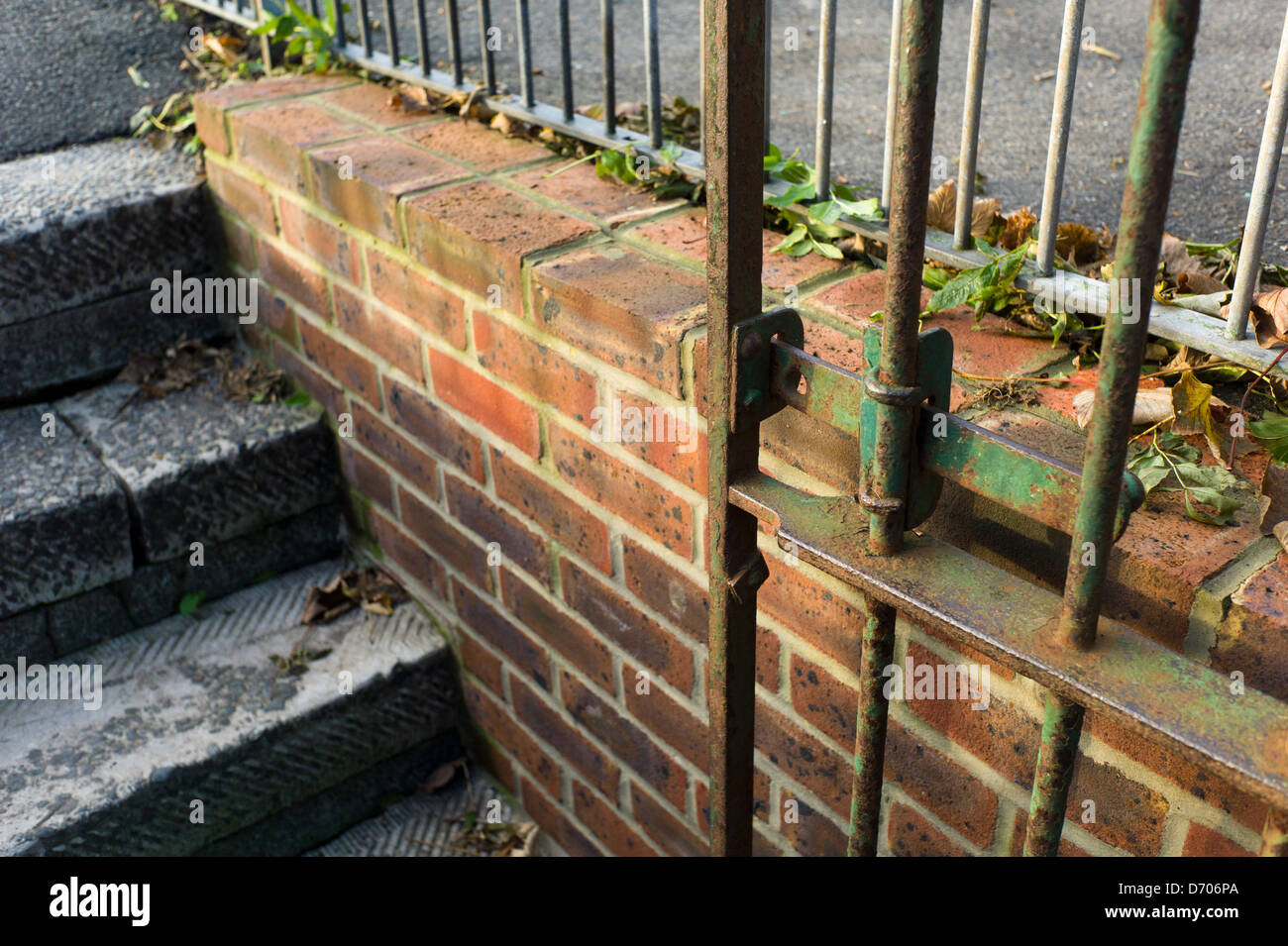 Rusty gate, brick wall and steps Stock Photo Alamy