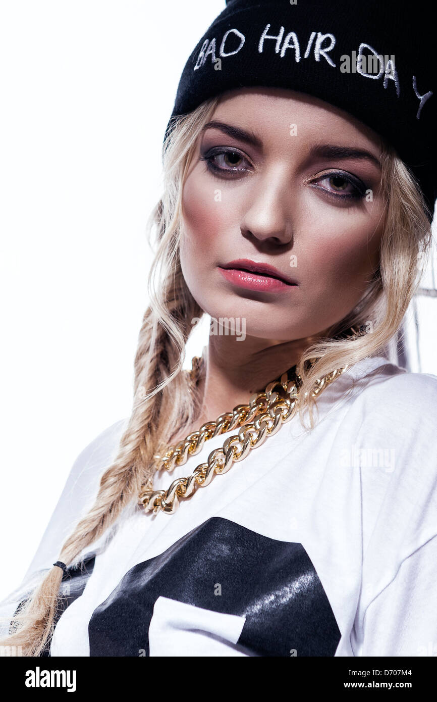 beautiful urban young woman wearing a woolen hat and gold chains Stock Photo