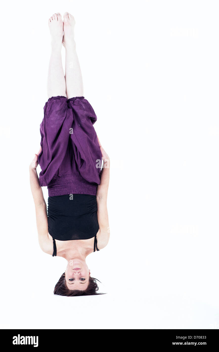 Young woman balancing on her head Stock Photo