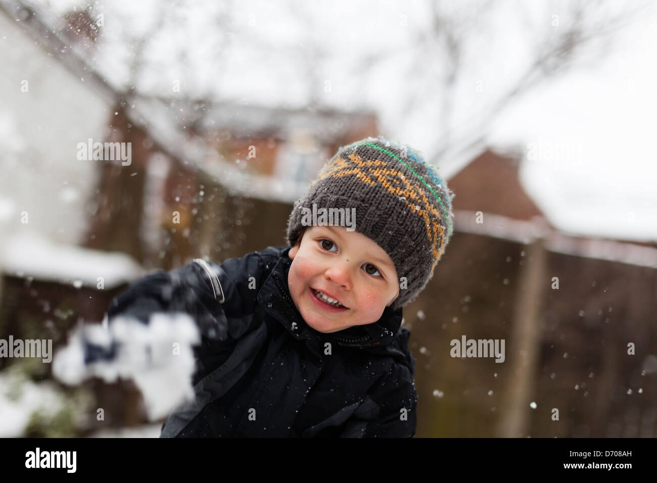 young boy throwing a snowball Stock Photo
