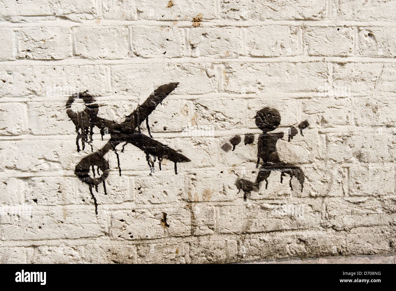 street art showing man being chased by scissors Stock Photo