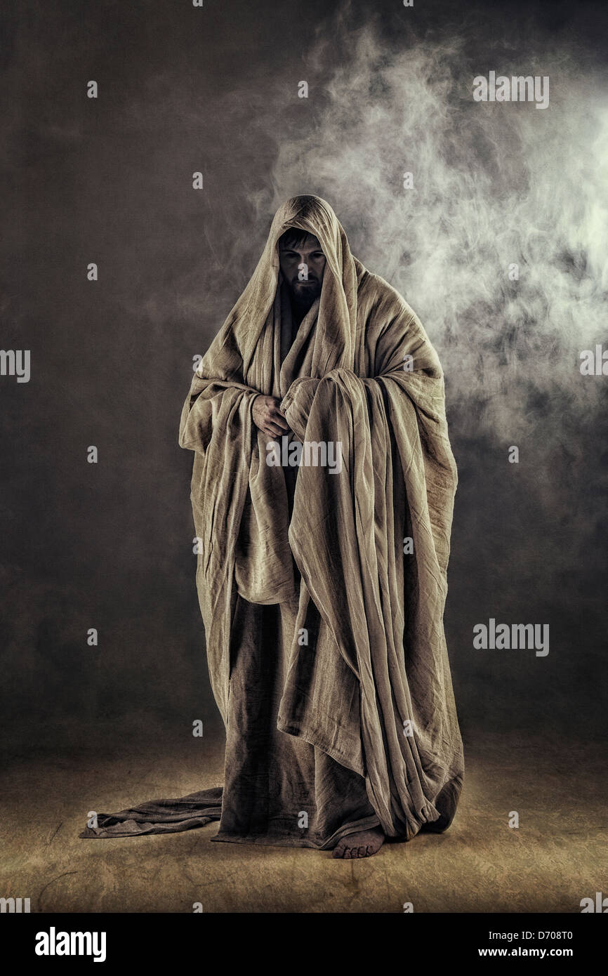cloaked figure in smoke Stock Photo