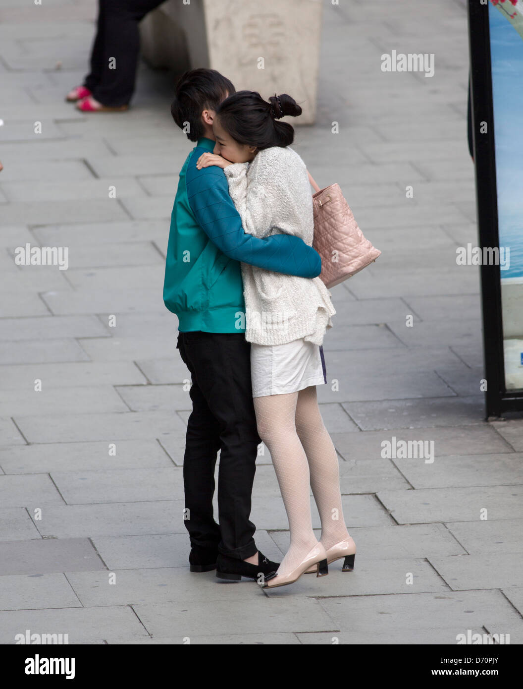 Young couple kissing in the street Stock Photo