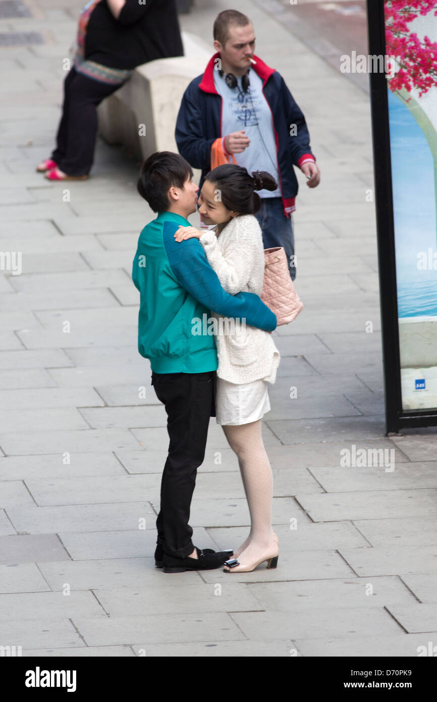 Young couple kissing in the street Stock Photo