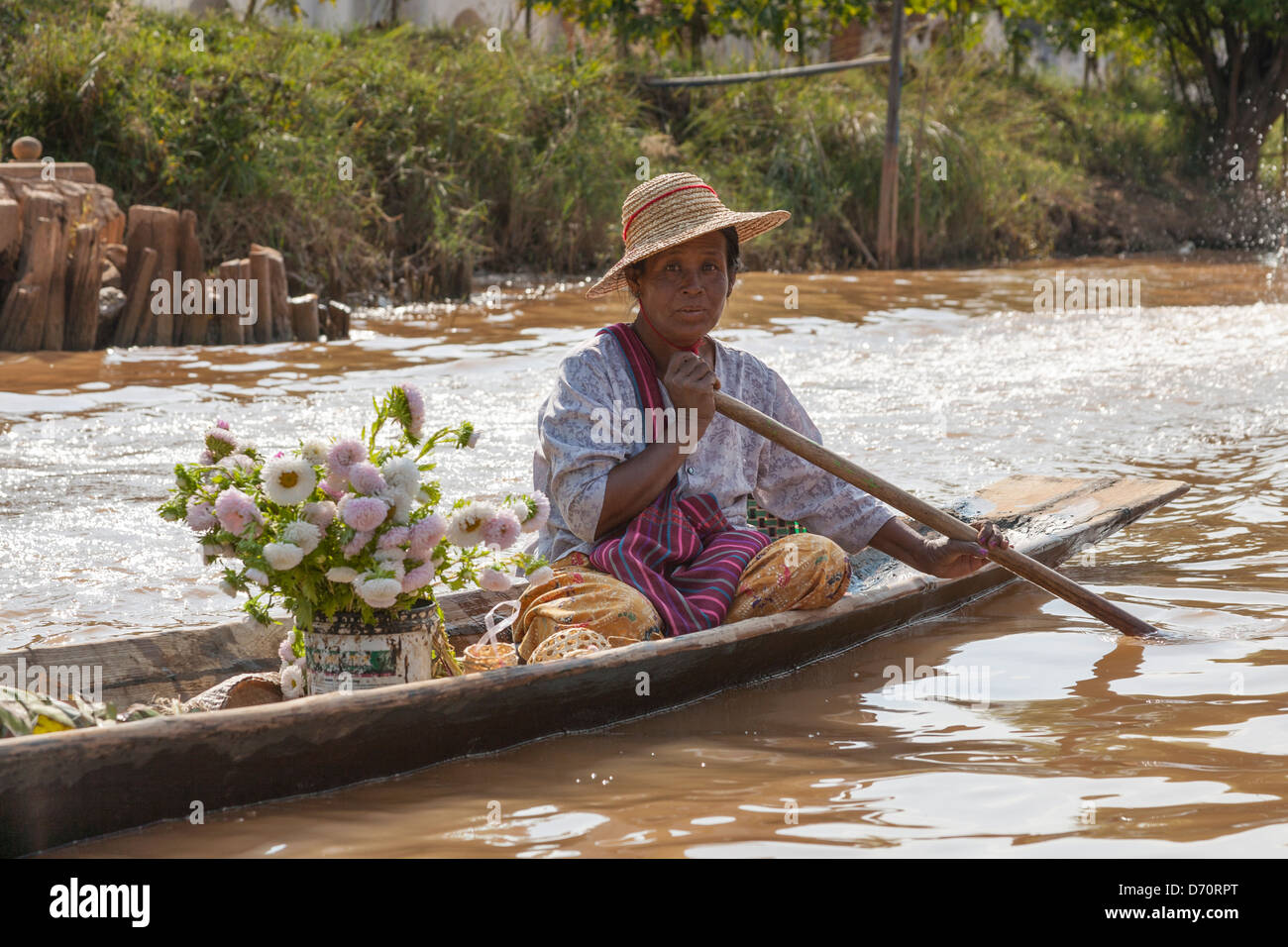 Woman rowing a canoe, Ywama village, Inle Lake, Shan State, Myanmar