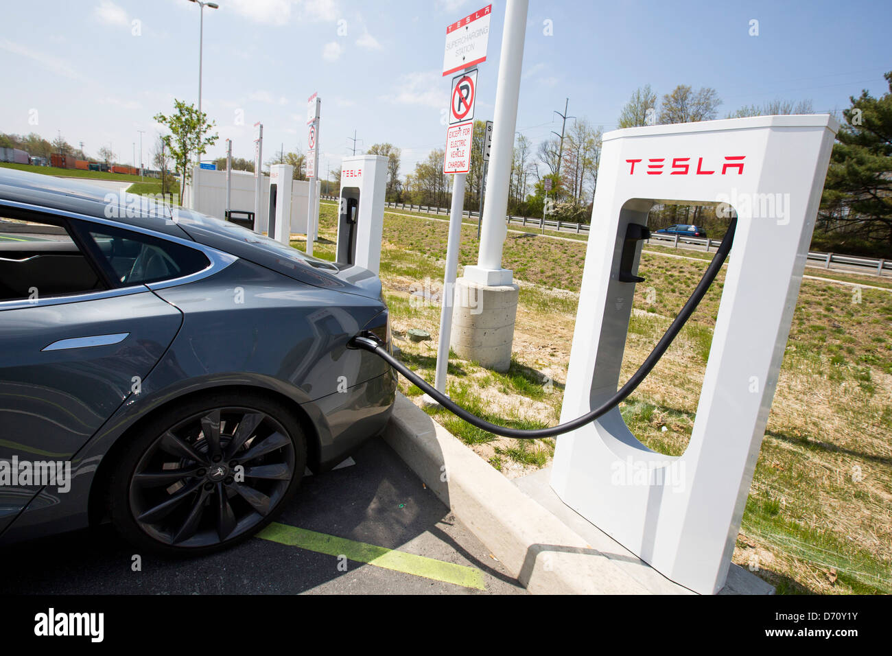 A Tesla Model S electric car Supercharging Station along Interstate 95 in Delaware.  Stock Photo