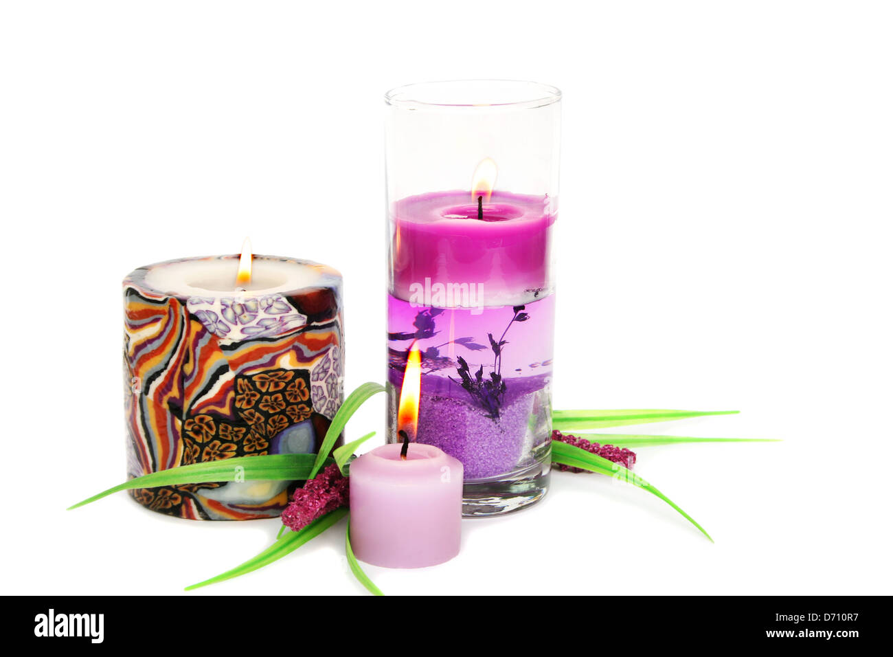 Pink burning candles and plant isolated on white background Stock Photo Alamy