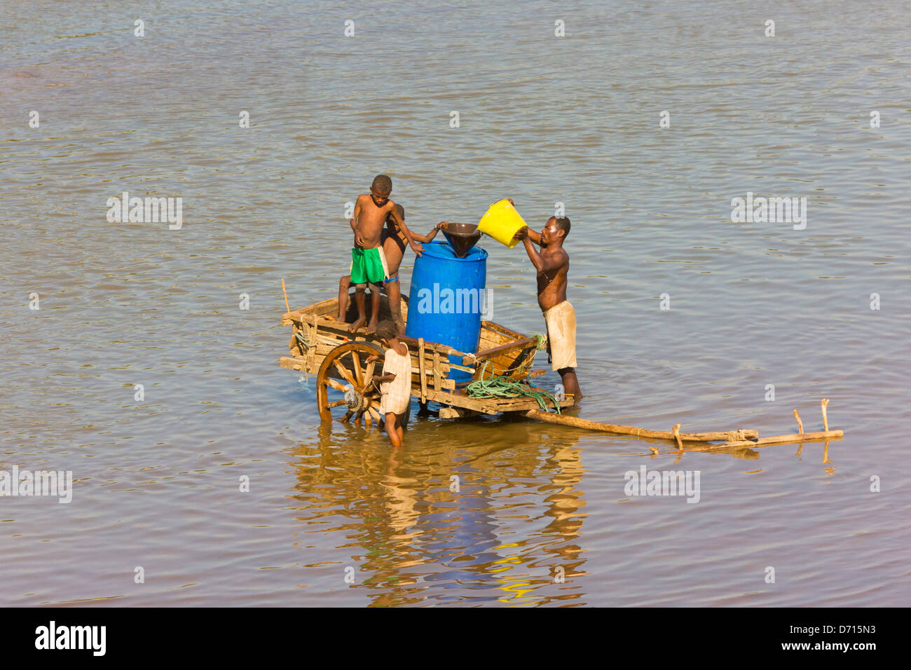 Fetching water in the river, Fort Dauphin, Madagascar Stock Photo