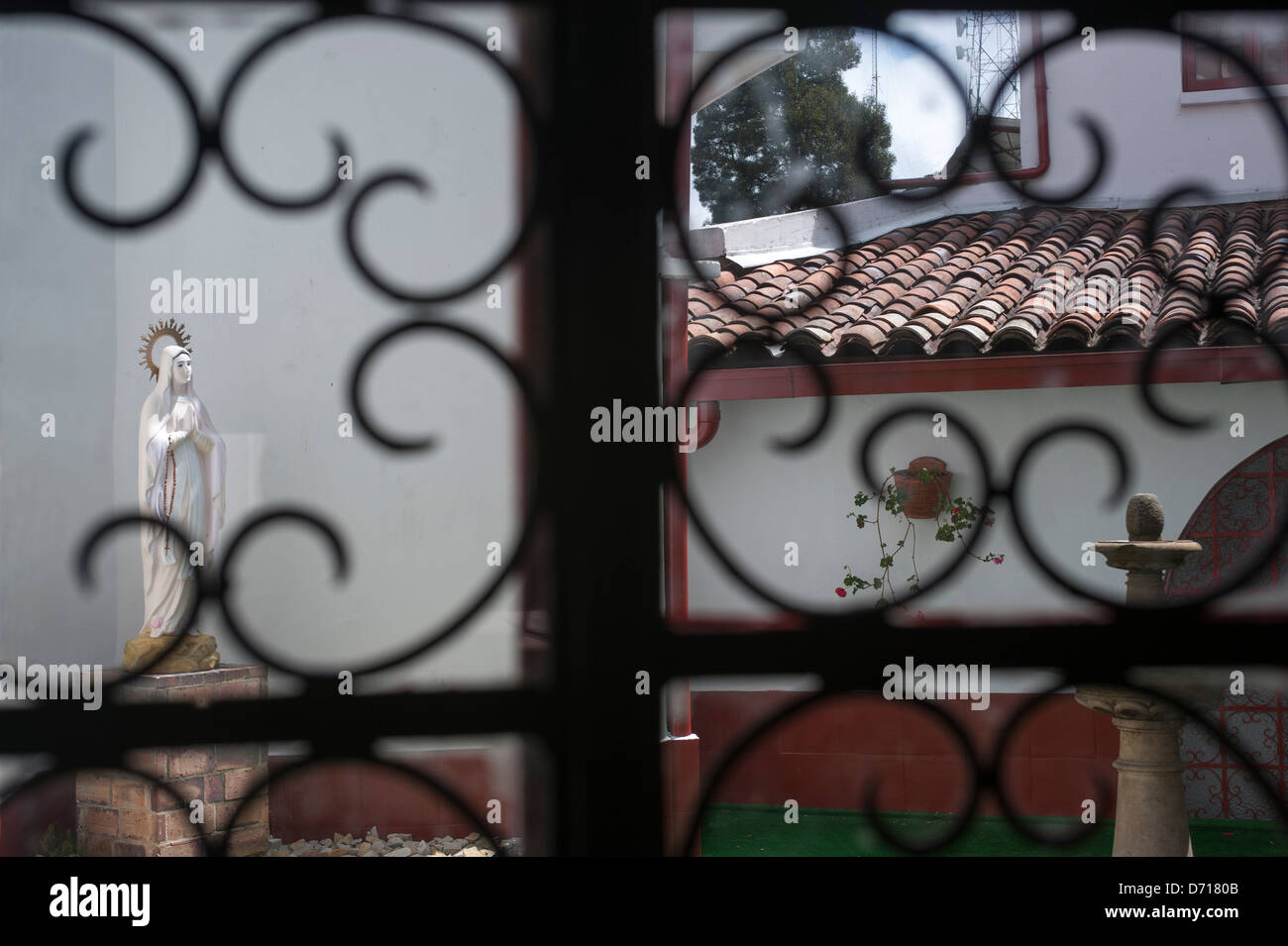 Wrought Iron Window Screen With Statue Of Madonna In Background At The