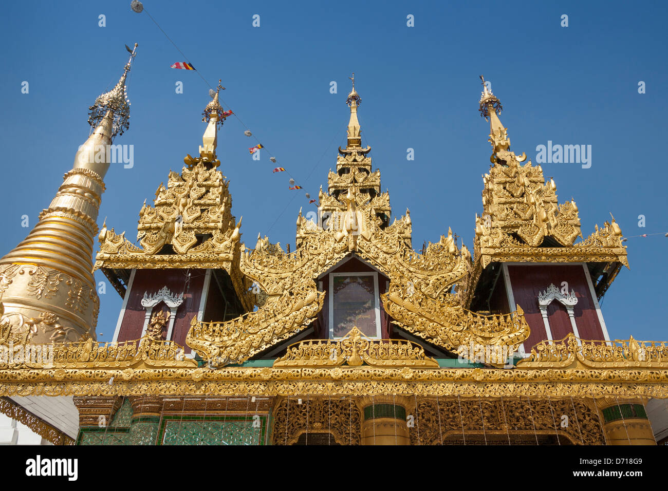 Ornate roof of a building and a stupa at Shwedagon Pagoda, Yangon, (Rangoon), Myanmar, (Burma) Stock Photo