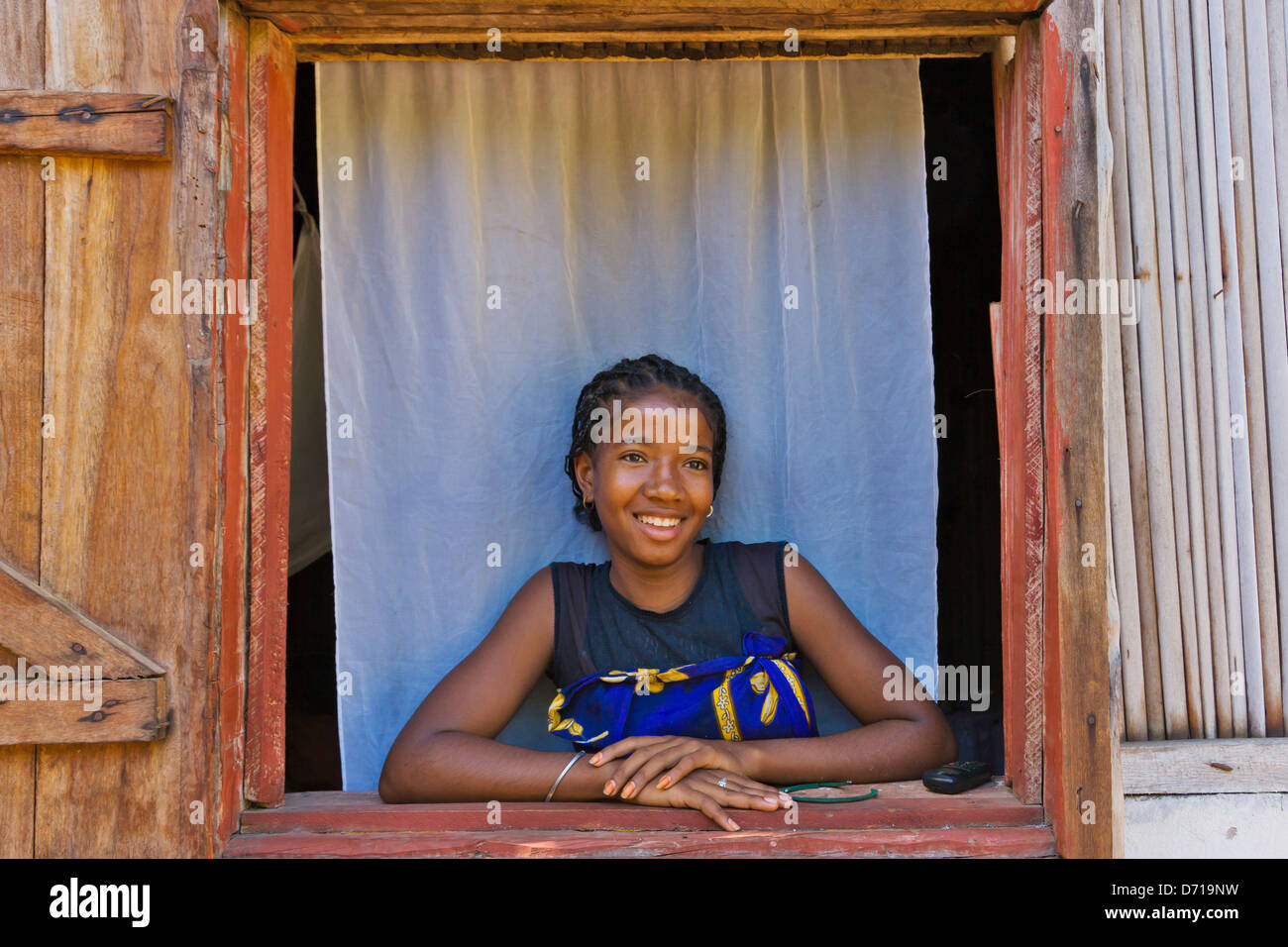 Young girl by the window, Nosy Be, Madagascar Stock Photo