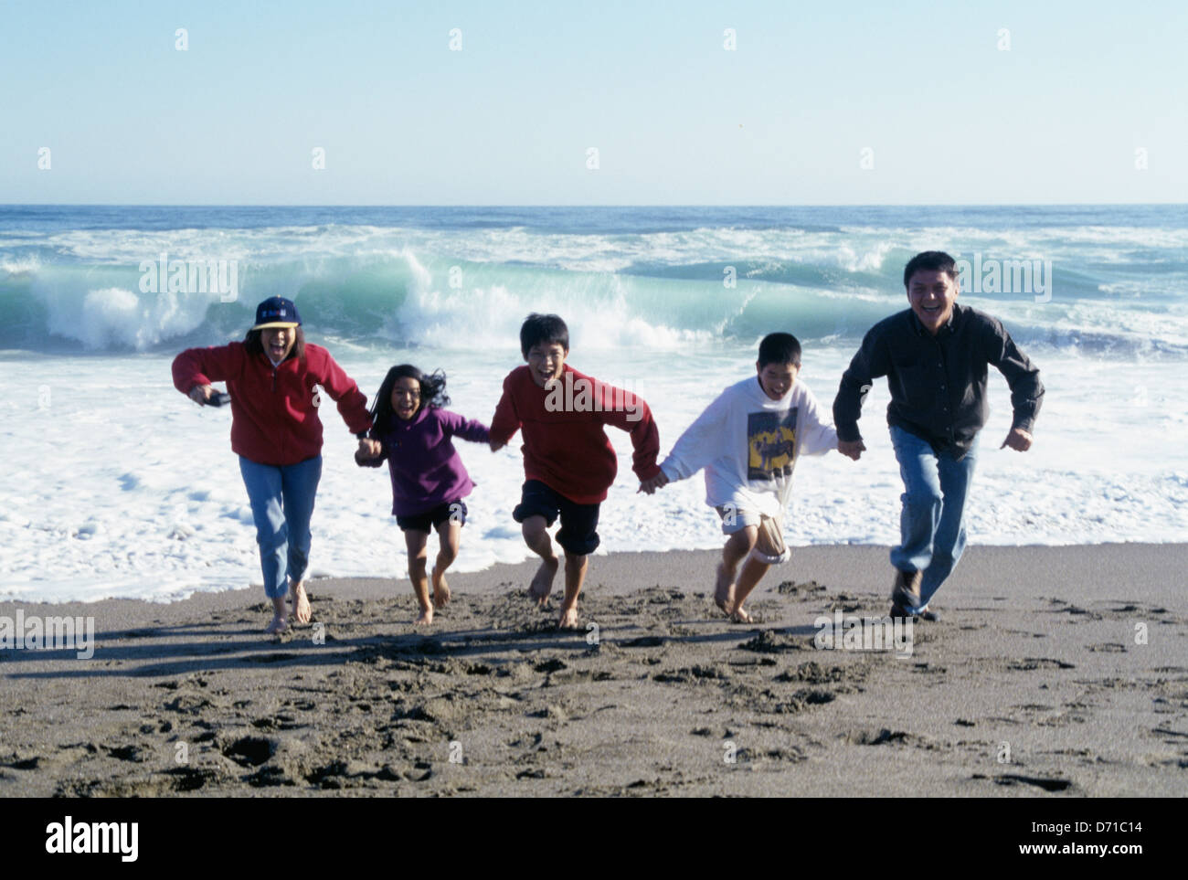 Happy asian family playing at the beach hi-res stock photography and ...